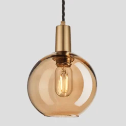 Sleek Tinted Glass Globe Pendant - 7 Inch - Amber -Industville Shop 7 Inch Pendant Tinted Glass Amber Globe Brass Sleek SL TGL GLP7 A BH Lit