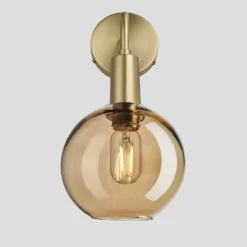 Sleek Tinted Glass Globe Wall Light - 7 Inch - Amber 10 Sleek Tinted Glass Globe Wall Light - 7 Inch - Amber -Industville Shop 7 Inch WallLight Glass Industville Lighting Globe BrassHolder Sleek SL TGL GLWL7 A BH SO Lit
